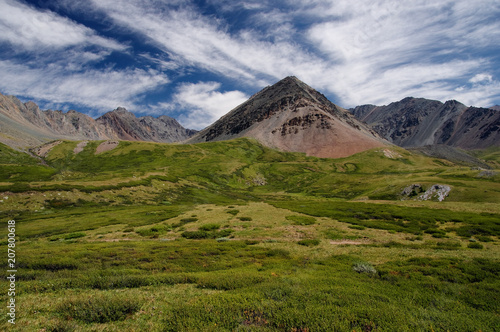 Wallpaper Mural Mountain valley with green grass and ranges of  hills rocks on a horizon skyline under blue sky Torontodigital.ca