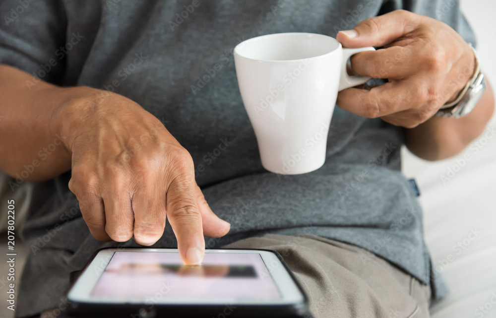 Senior male hands using a digital tablet. Senior male hands using a digital tablet.