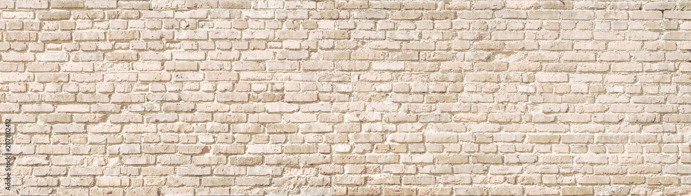 Beige old brick wall panorama.