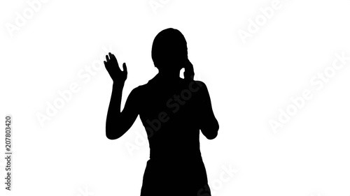Silhouette Portrait of happy young Woman Talking On Mobile Phone