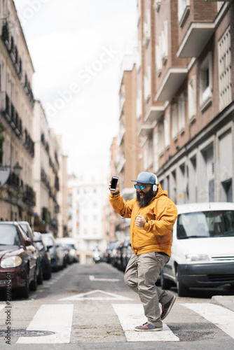 Happy man walking down a street in Madrid