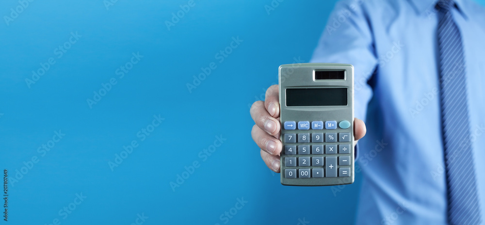 Businessman showing calculator. Business concept Businessman showing calculator. Business concept