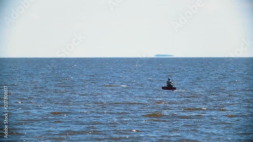 Professional kiteboarder flying with sail on the kiteboard over the sea