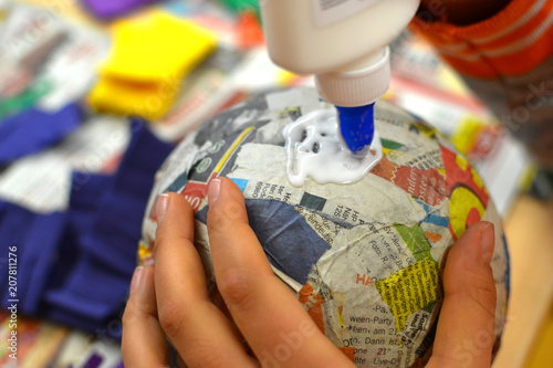 Children hands are making a pinata.