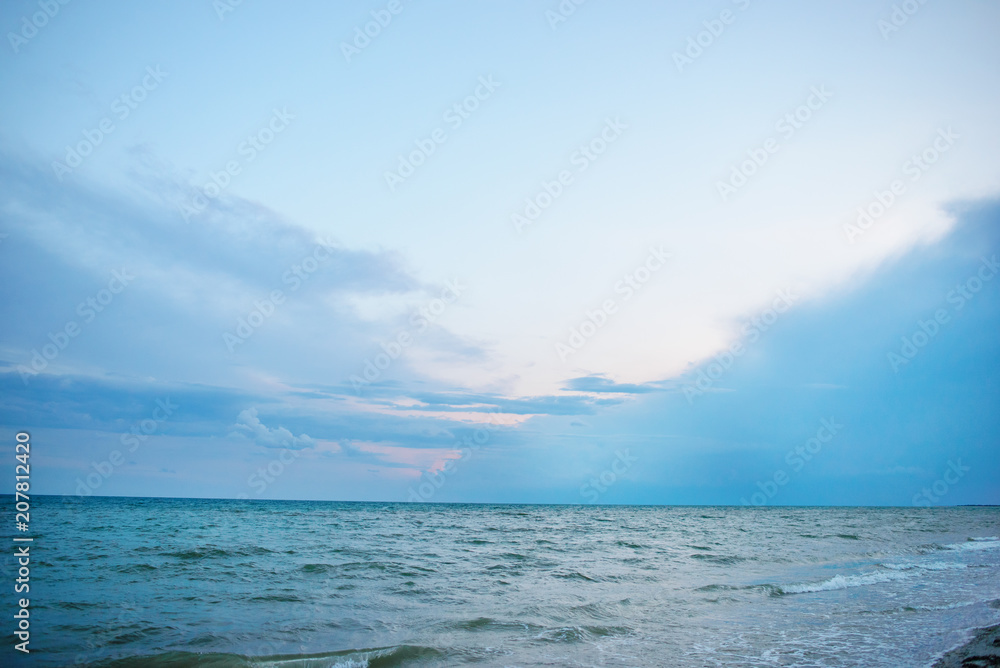 the blue ocean with dull clouds on a lovely sunny day