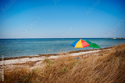 umbrella on the beach with cloudy blue sky in background