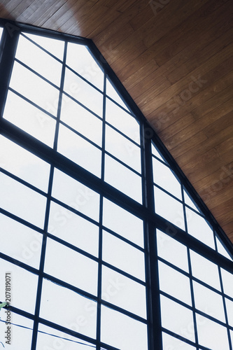 Large black frame windows. Concept store, shopping center, restaurant, coffee shop. Minimalism contemporary design interior