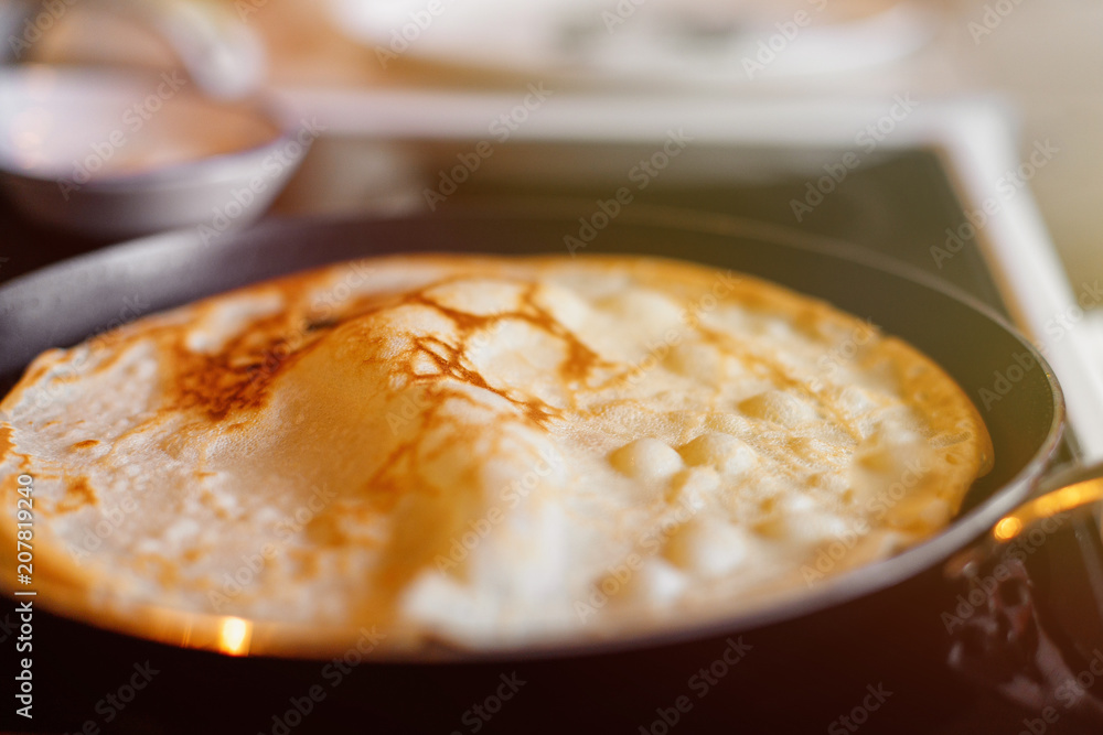 Cooking pancakes in the kitchen. Pancake in the pan Cooking pancakes in the kitchen. Pancake in the pan