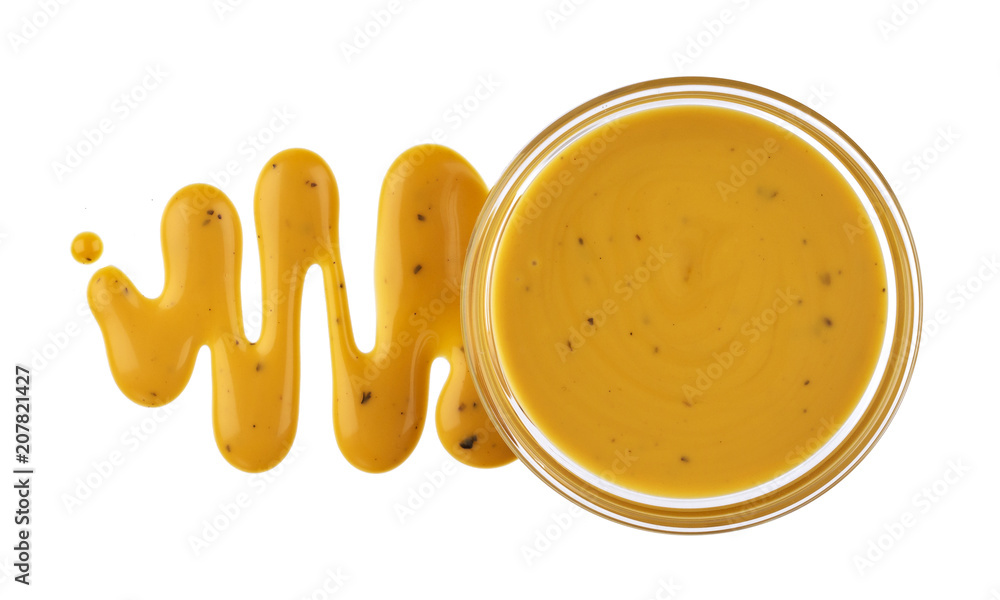 Mustard sauce in bowl isolated on white background. Top view - obrazy, fototapety, plakaty 