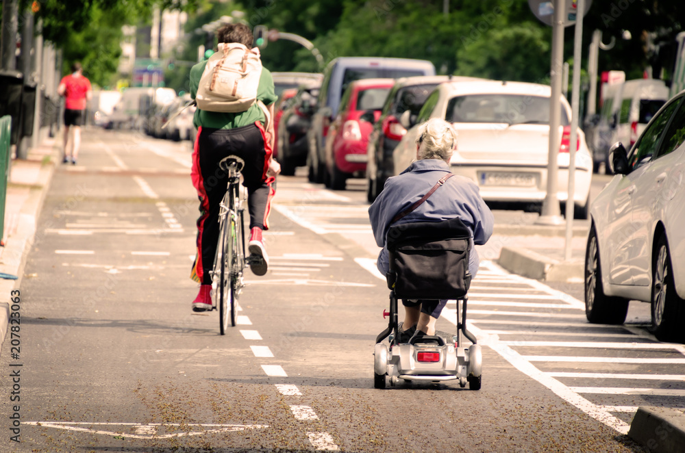 Old woman on a wheel chair in the streets of Madrid