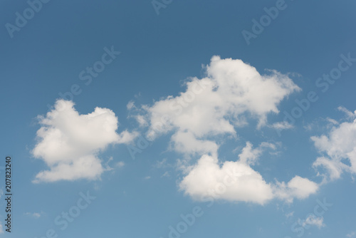 Blue sky with group of white clouds as wallpaper or background.