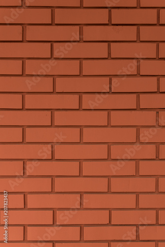 Strong red vertical brick wall background, surface. Red, orange tiles.