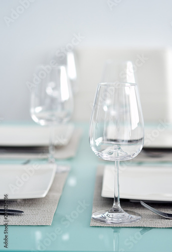 Table setting with a wine glasses, cutlery and plates