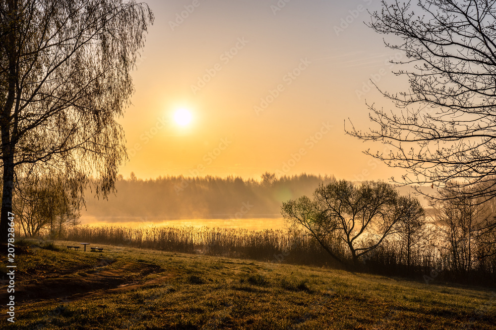 Sunrise landscape at river. Morning fog with forest and lake and
