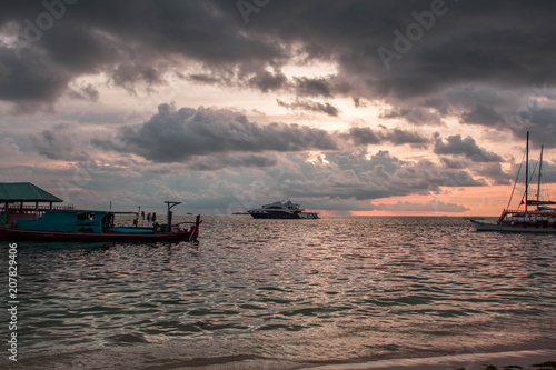 Gorgeous view of sunset on Indian Ocean, Maldives. Some boats on horizon line. Amazing nature landscape background.