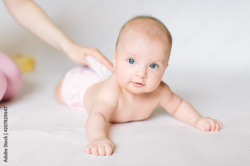 After shower baby wrapped into towels on the diaper table After shower baby wrapped into towels on the diaper table