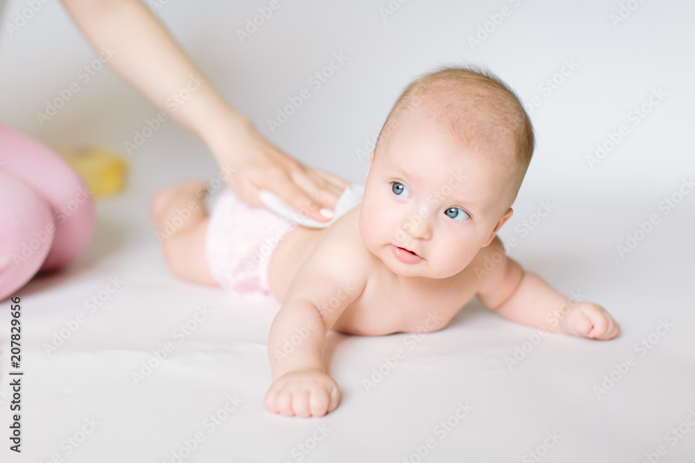 After shower baby wrapped into towels on the diaper table After shower baby wrapped into towels on the diaper table