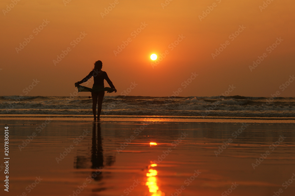 woman silhouette walking at sunset