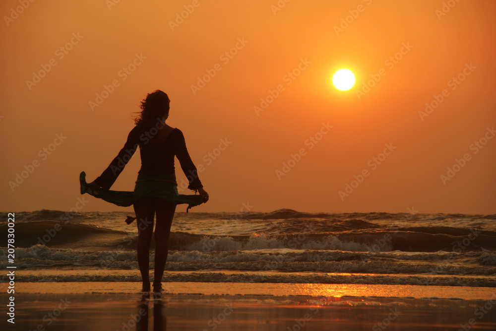 woman silhouette walking at sunset