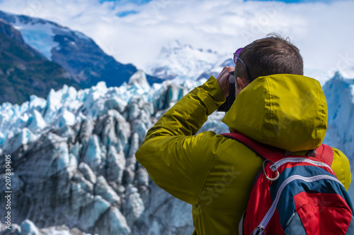 Photographer taking a picture of the ice of glacier. Perito Moreno Glacier, Los Glaciares National Park, Argentina © Dudarev Mikhail