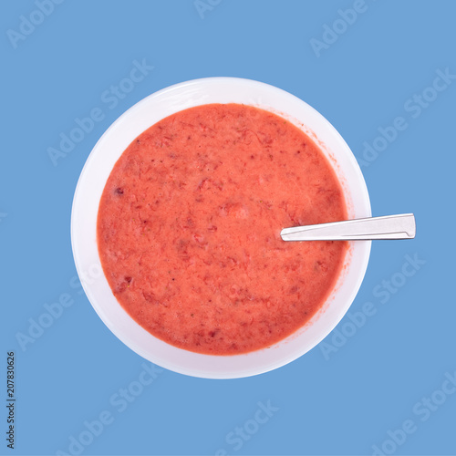 Fresh homemade yogurt, strawberries and sour cream mixed by using blender, little boy blue color background with copy space for text