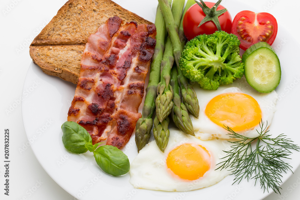 Fried eggs with bacon on the wooden table. Fried eggs with bacon on the wooden table.