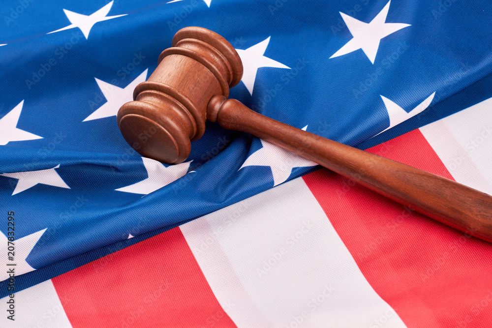 Wooden gavel on USA flag. Close up judge gavel on American flag. Law and criminal.
