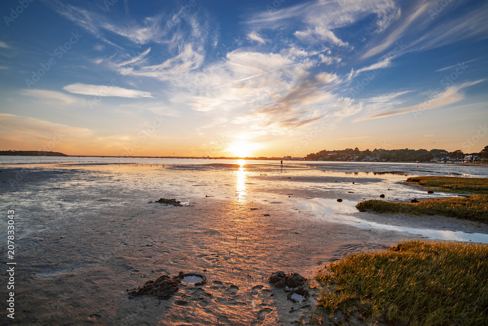 Vibrant sunset against a sunny sky over Poole Harbour in Dorset, UK