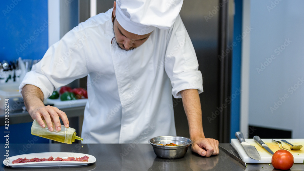 young chef preparing a plate decoration
