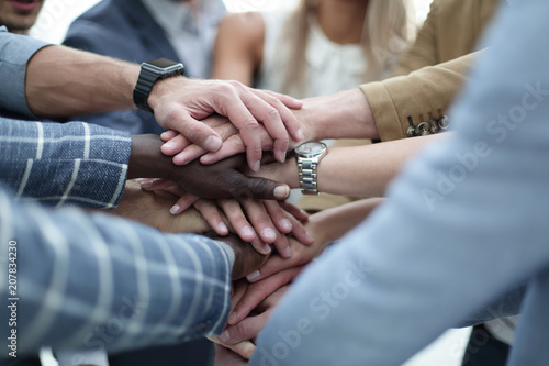 Close-Up of hands business team showing unity with putting their hands together