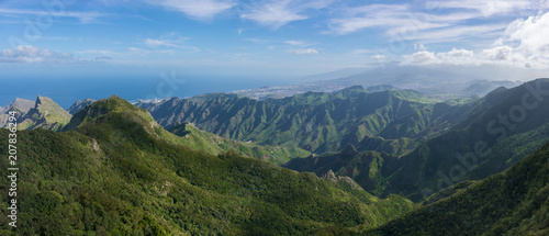 Majestic panoramic view of the Roques de Anaga. Beautiful mountain range and green valley with ocean on the background. Tenerife, Canary Islands.