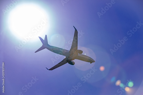 Large passenger plane flying in the blue sky