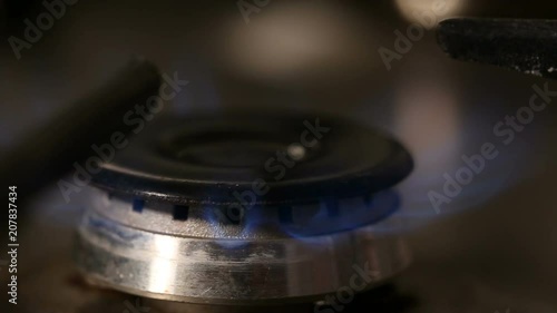Hand lighting one gas burner - close up view
 photo