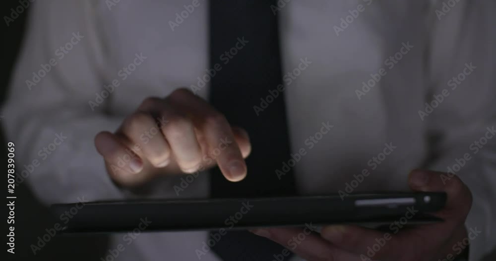 5 Front view of office worker working late on a tablet, 4k slow motion, glow. 5 Front view of office worker working late on a tablet, 4k slow motion, glow.