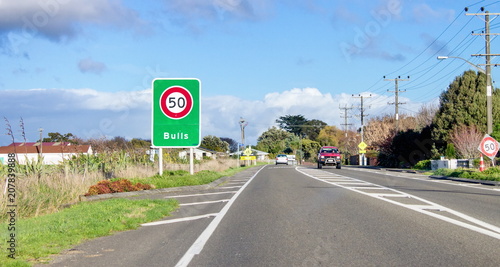 Road sign designating a fifty kilometer per hour speed zone travelling through the town of Bulls in the Rangitikei District. of New Zealand photo
