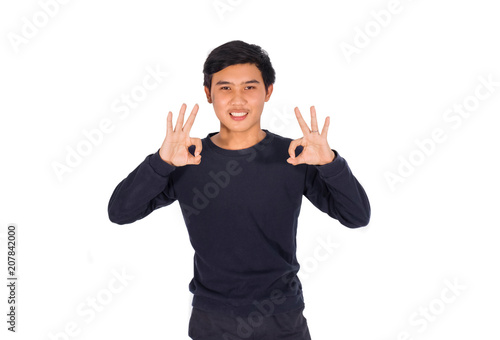 A Thai man is showing an OK sign by his two hands