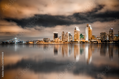 Beautiful night skyline of San Diego California with bay of water and lit buildings