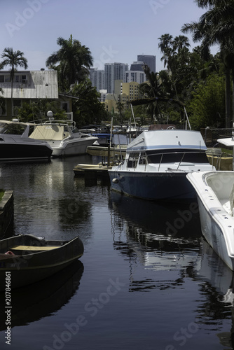 Boats in a Miami canal sunny with buildings in back