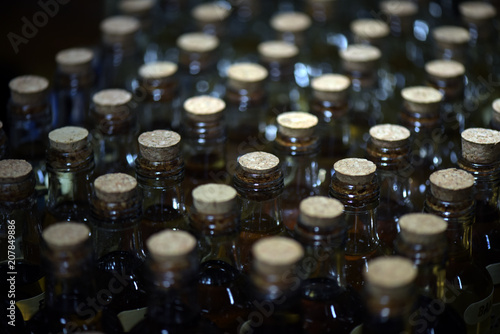 Closeup of bottlenecks of bottles of pinga