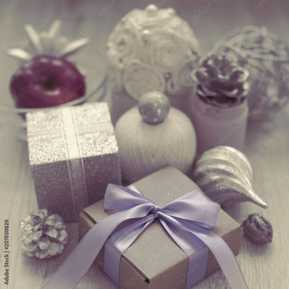 Surrealism Christmas composition with gift box with satin ribbon bow materials for decorating Christmas toy bump. Surrealism Christmas composition with gift box with satin ribbon bow materials for decorating Christmas toy bump.