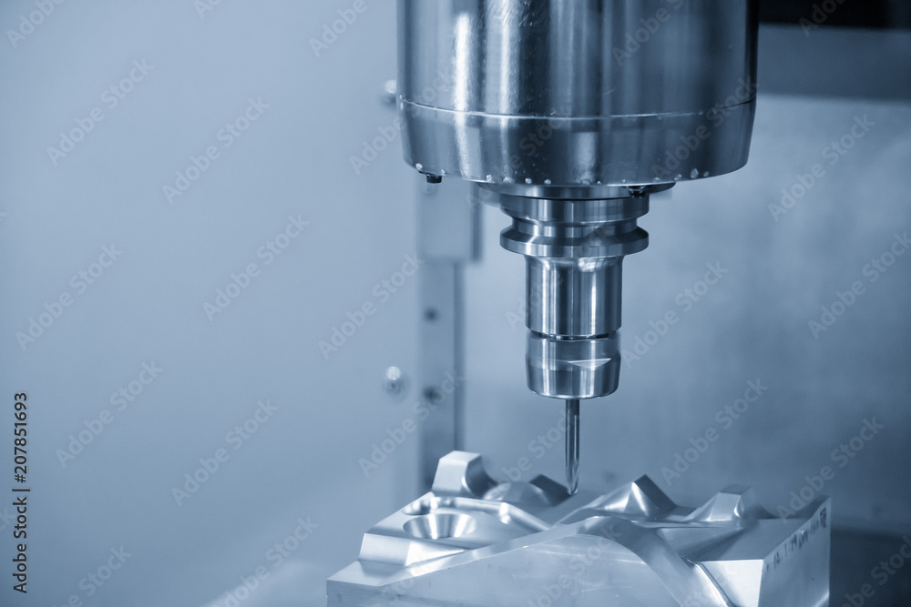 The CNC milling machine cutting the automotive mold part with the solid ball endmill tool. Modern manufacturing process. The CNC milling machine cutting the automotive mold part with the solid ball endmill tool. Modern manufacturing process.