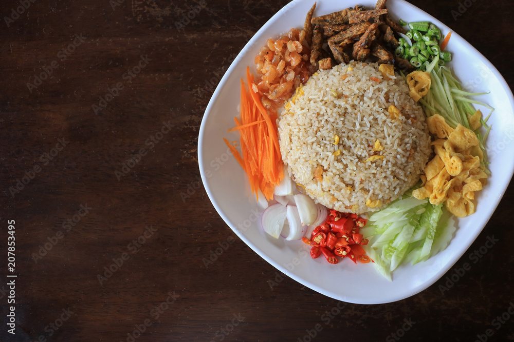 Top view Food is in a plate of white rice placed on an old wooden table Top view Food is in a plate of white rice placed on an old wooden table