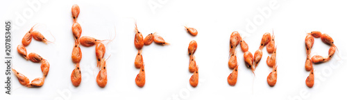 The word "Shrimp" consists of boiled shrimps. White background, isolated, top view.