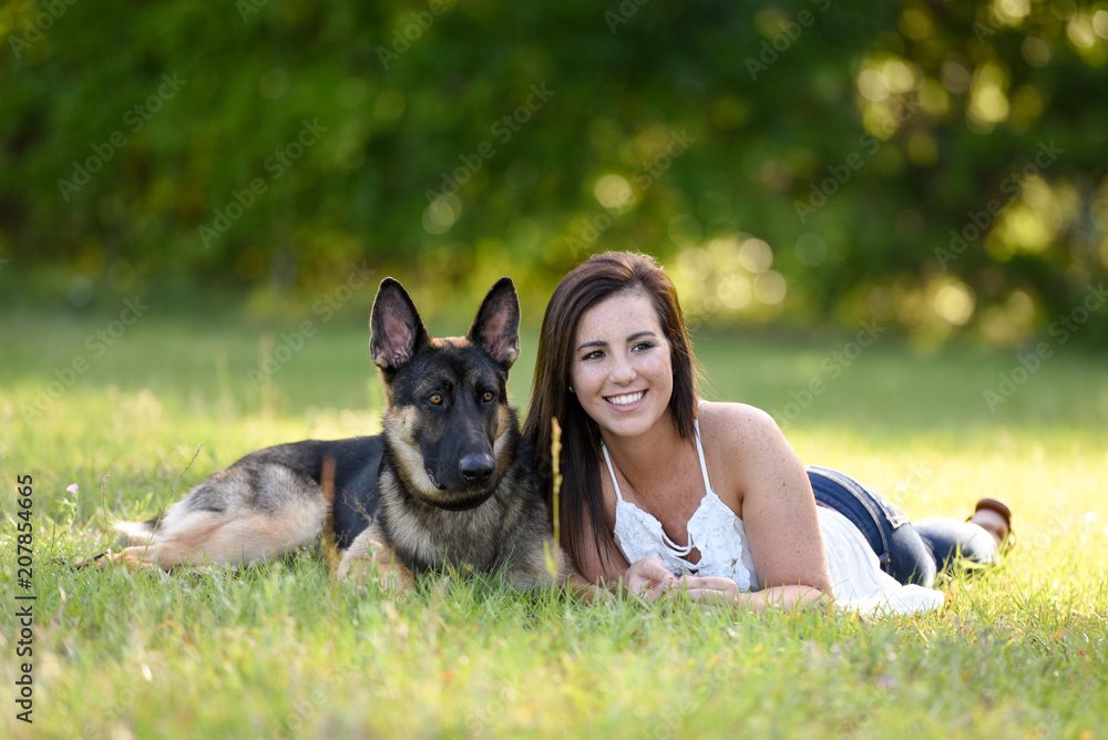 Young woman with German Shepherd dog in the gorgeous summer field Young woman with German Shepherd dog in the gorgeous summer field