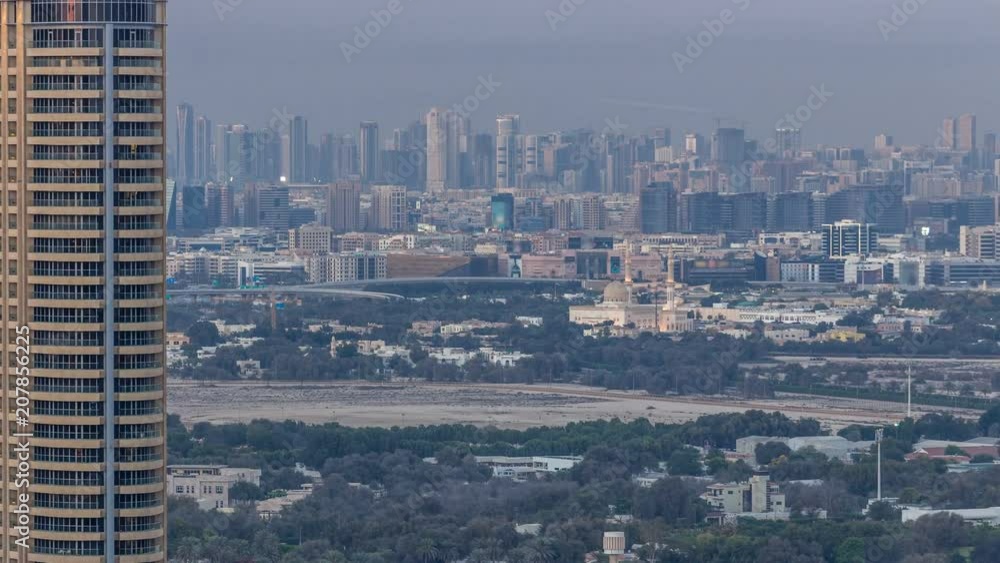 Skyline view of Deira and Sharjah districts in Dubai timelapse at sunset, UAE. Skyline view of Deira and Sharjah districts in Dubai timelapse at sunset, UAE.