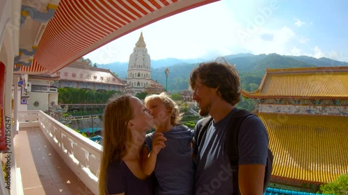 Slowmotion shot of a family shooting selfie while visiting the Kek Lok Si temple on Penang island, Malaysia. photo