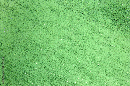 Green shiny textured acrylic paint with glitter background