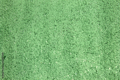 Green shiny textured acrylic paint with glitter background