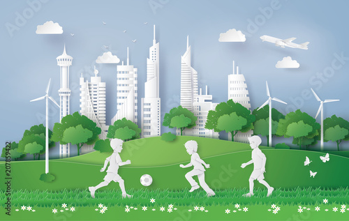 boy plaing football in the city park