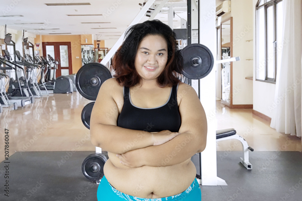 Fat woman crossed her arms in the gym center Stock Photo Adobe Stock